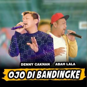 Dengarkan lagu Ojo Di Bandingke nyanyian Denny Caknan dengan lirik